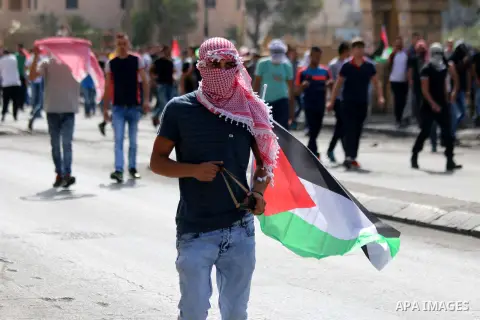 A Palestinian protester uses a sling shot to throw stones at Israeli security forces during clashes in the West Bank city of Bethlehem, on October 13, 2015. A wave of stabbings that hit Israel, Jerusalem and the West Ban...