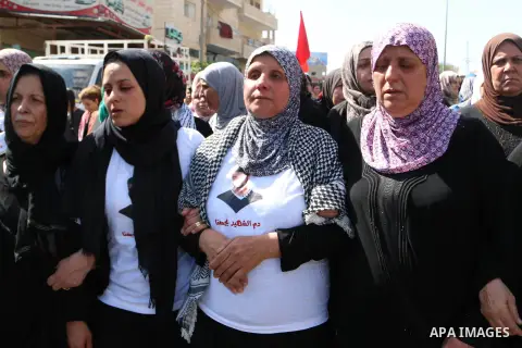 The Mother and Sister of the body of 27-year-old Moataz Zawahra, who was killed by Israeli security forces in the clashes with Palestinian protesters, mourn during his funeral in the West Bank city of Bethlehem October 1...