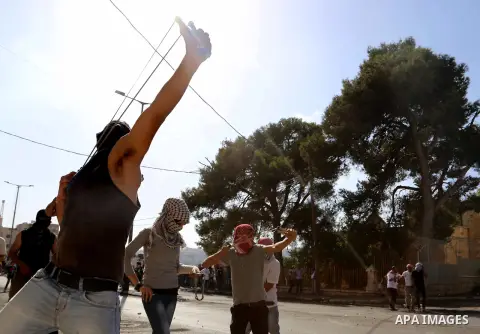A Palestinian protester uses a sling to throw stones at Israeli troops during clashes in the West Bank city of Bethlehem October 14, 2015. Seven Israelis and 30 Palestinians, including children and assailants, have been...