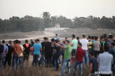 Palestinian protesters gather during clashes with Israeli troops near a border fence between Israel and the Gaza Strip on October 14, 2015 east of Bureij in central Gaza. The outbreak of violence between Palestinians and...