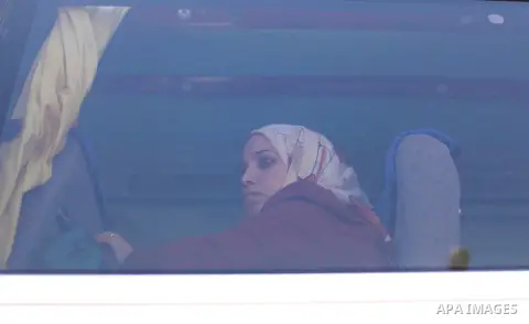 A Palestinian woman sits in a bus as she returns to Gaza, at the Rafah border crossing between Egypt and southern Gaza Strip October 15, 2015. Egypt opened the Rafah border crossing on Thursday for one day to allow stran...
