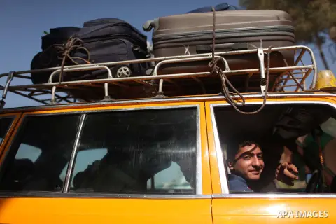 Palestinians sit in a car as they return to Gaza, at the Rafah border crossing between Egypt and southern Gaza Strip October 15, 2015. Egypt opened the Rafah border crossing on Thursday for one day to allow stranded Pale...