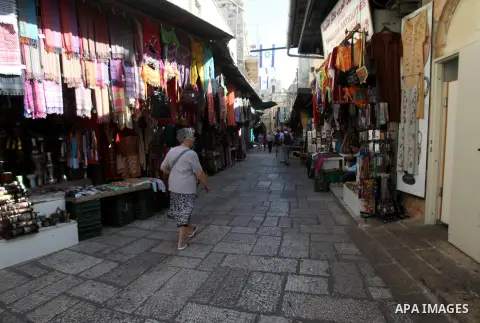 People walk in a market in Jerusalem's Old city on October 15, 2015. Seven Israelis and 30 Palestinians, including children and assailants, have been killed in two weeks of bloodshed in Israel, Jerusalem and the occupied...