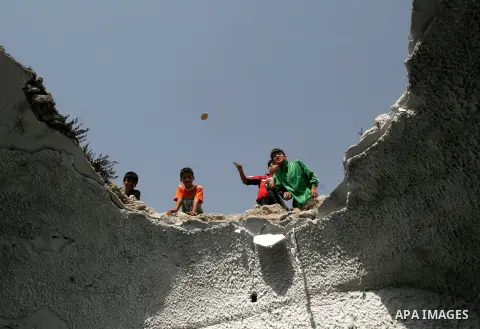 A file picture taken on February 10, 2007, shows Palestinian boys throw stones at the Joseph's Tomb, in the West Bank city of Nablus. A group of Palestinians have set fire to Joseph's Tomb in Nablus in the occupied Pales...