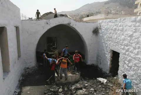 A file picture taken on February 10, 2007, shows Palestinian boys play at the Joseph's Tomb, in the West Bank city of Nablus. A group of Palestinians have set fire to Joseph's Tomb in Nablus in the occupied Palestinian W...