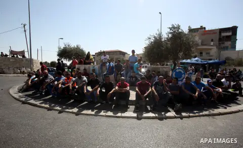 Israeli police stand guard as Palestinian Muslims pray on the streets of the Wadi al-Joz neighbourhood in east Jerusalem during the Friday prayers following restrictions by Israeli police preventing Palestinians under 40...