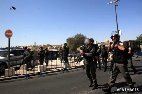 Israeli policemen fire tear gas towards Palestinian worshipers after Friday prayers on the streets of the Wadi al-Joz neighbourhood in east Jerusalem following restrictions by Israeli police preventing Palestinians under...