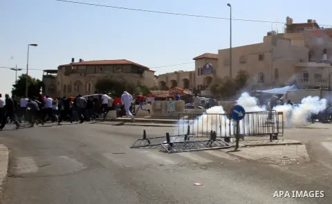 Israeli policemen fire tear gas towards Palestinian worshipers after Friday prayers on the streets of the Wadi al-Joz neighbourhood in east Jerusalem following restrictions by Israeli police preventing Palestinians under...