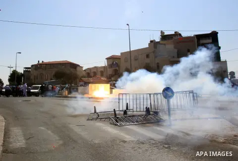 Israeli policemen fire tear gas towards Palestinian worshipers after Friday prayers on the streets of the Wadi al-Joz neighbourhood in east Jerusalem following restrictions by Israeli police preventing Palestinians under...