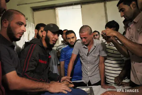 Relatives of 20-year-old Palestinian Yahya Farahat, who was killed by Israeli security forces during clashes in the northern Gaza Strip, mourn over his body at a hospital morgue in Gaza city on October 16, 2015. The unre...