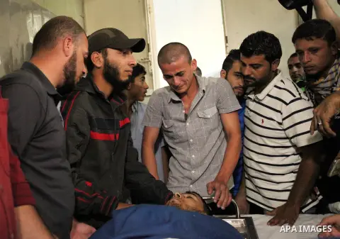 Relatives of 20-year-old Palestinian Yahya Farahat, who was killed by Israeli security forces during clashes in the northern Gaza Strip, mourn over his body at a hospital morgue in Gaza city on October 16, 2015. The unre...