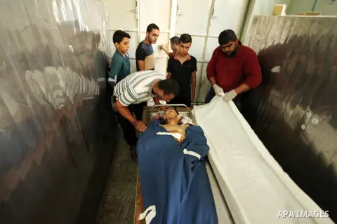 Relatives of 20-year-old Palestinian Yahya Farahat, who was killed by Israeli security forces during clashes in the northern Gaza Strip, mourn over his body at a hospital morgue in Gaza city on October 16, 2015. The unre...
