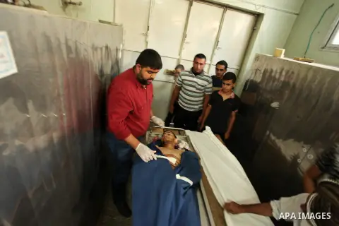 Relatives of 20-year-old Palestinian Yahya Farahat, who was killed by Israeli security forces during clashes in the northern Gaza Strip, mourn over his body at a hospital morgue in Gaza city on October 16, 2015. The unre...