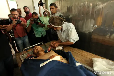Relatives of 20-year-old Palestinian Yahya Farahat, who was killed by Israeli security forces during clashes in the northern Gaza Strip, mourn over his body at a hospital morgue in Gaza city on October 16, 2015. The unre...
