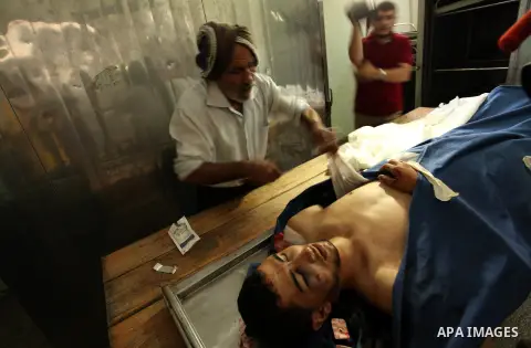 Relatives of 20-year-old Palestinian Yahya Farahat, who was killed by Israeli security forces during clashes in the northern Gaza Strip, mourn over his body at a hospital morgue in Gaza city on October 16, 2015. The unre...