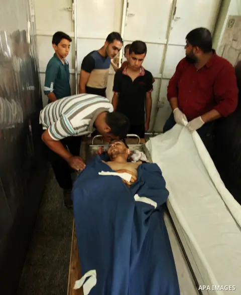 Relatives of 20-year-old Palestinian Yahya Farahat, who was killed by Israeli security forces during clashes in the northern Gaza Strip, mourn over his body at a hospital morgue in Gaza city on October 16, 2015. The unre...