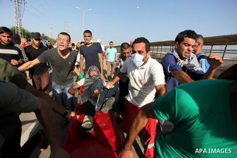 Palestinian protester carry an injured comrade during clashes with Israeli security forces at the Erez crossing checkpoint in the northern Gaza Strip October 16, 2015. The unrest that has engulfed Jerusalem and the occup...