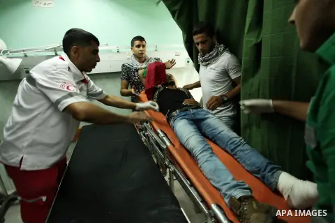 An injured Palestinian protester, who was wounded during clashes with Israeli security forces in the east of Gaza city, recieves treatment at al-Shifa hospital in Gaza city on October 16, 2015. The unrest that has engulf...