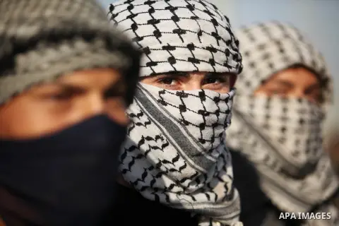Masked Palestinian protersters look on during clashes with Israeli security forces at the Erez crossing checkpoint in the northern Gaza Strip October 16, 2015. The unrest that has engulfed Jerusalem and the occupied West...