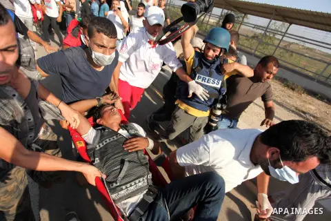 Palestinian protester carry an injured comrade during clashes with Israeli security forces at the Erez crossing checkpoint in the northern Gaza Strip October 16, 2015. The unrest that has engulfed Jerusalem and the occup...