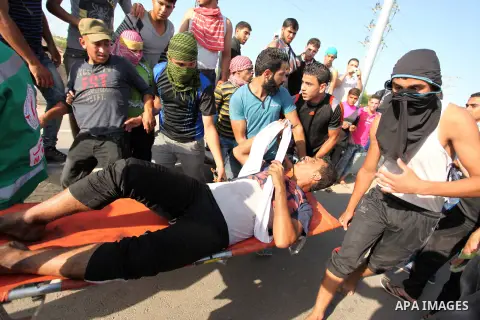 Palestinian protester carry an injured comrade during clashes with Israeli security forces at the Erez crossing checkpoint in the northern Gaza Strip October 16, 2015. The unrest that has engulfed Jerusalem and the occup...