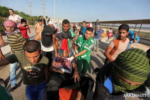Palestinian protester carry an injured comrade during clashes with Israeli security forces at the Erez crossing checkpoint in the northern Gaza Strip October 16, 2015. The unrest that has engulfed Jerusalem and the occup...