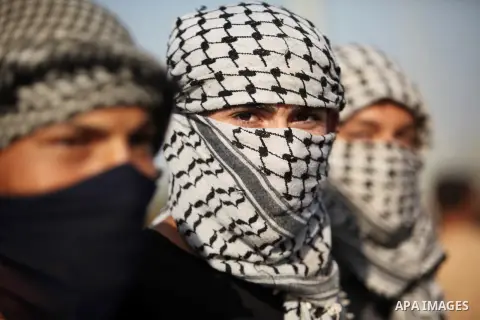 Masked Palestinian protersters look on during clashes with Israeli security forces at the Erez crossing checkpoint in the northern Gaza Strip October 16, 2015. The unrest that has engulfed Jerusalem and the occupied West...