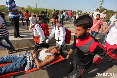 Palestinian protester carry an injured comrade during clashes with Israeli security forces at the Erez crossing checkpoint in the northern Gaza Strip October 16, 2015. The unrest that has engulfed Jerusalem and the occup...