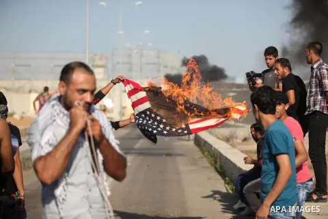 A Palestinian protester burns U.S flag during clashes with Israeli security forces at the Erez crossing checkpoint in the northern Gaza Strip October 16, 2015. The unrest that has engulfed Jerusalem and the occupied West...