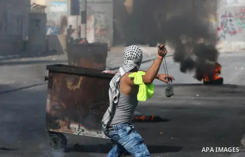 A Palestinian protester hurls stones towards Israeli security forces during clashes at the main entrance of the West Bank city of Bethlehem on October 16, 2015. The unrest that has engulfed Jerusalem and the occupied Wes...