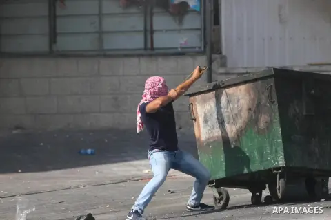 A Palestinian protester hurls stones towards Israeli security forces during clashes at the main entrance of the West Bank city of Bethlehem on October 16, 2015. The unrest that has engulfed Jerusalem and the occupied Wes...