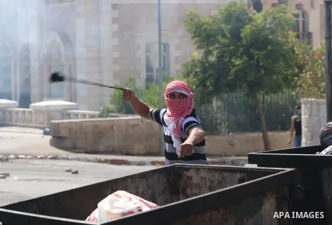 A Palestinian protester hurls stones towards Israeli security forces during clashes at the main entrance of the West Bank city of Bethlehem on October 16, 2015. The unrest that has engulfed Jerusalem and the occupied Wes...