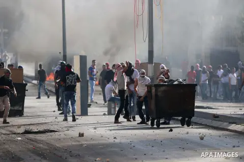 Palestinian protesters throw stones towards Israeli security forces during clashes at the main entrance of the West Bank city of Bethlehem on October 16, 2015. The unrest that has engulfed Jerusalem and the occupied West...