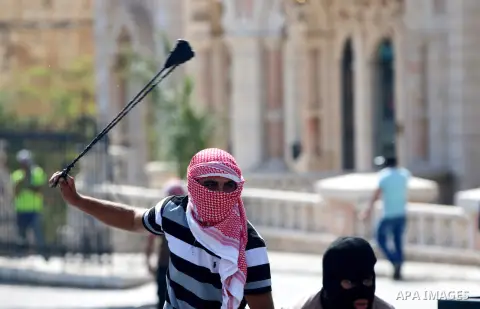 A Palestinian protester hurls stones towards Israeli security forces during clashes at the main entrance of the West Bank city of Bethlehem on October 16, 2015. The unrest that has engulfed Jerusalem and the occupied Wes...