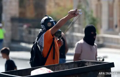 A Palestinian protester hurls stones towards Israeli security forces during clashes at the main entrance of the West Bank city of Bethlehem on October 16, 2015. The unrest that has engulfed Jerusalem and the occupied Wes...