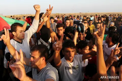 Palestinian protesters shot slogans during a demonstration near the border fence between Israel and the southern Gaza Strip October 16, 2015. The unrest that has engulfed Jerusalem and the occupied West Bank, the most se...