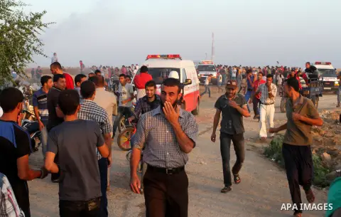 Palestinian protesters run for cover from tear gas during clashes with Israeli security forces near the border fence between Israel and the southern Gaza Strip October 16, 2015. The unrest that has engulfed Jerusalem and...
