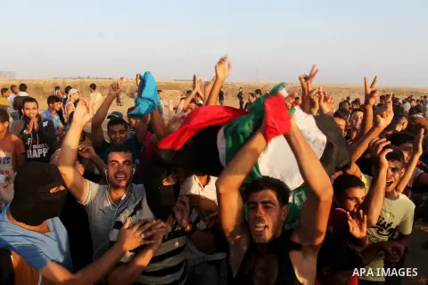 Palestinian protesters shot slogans during a demonstration near the border fence between Israel and the southern Gaza Strip October 16, 2015. The unrest that has engulfed Jerusalem and the occupied West Bank, the most se...