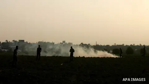 Palestinian protesters run for cover from tear gas during clashes with Israeli security forces near the border fence between Israel and the southern Gaza Strip October 16, 2015. The unrest that has engulfed Jerusalem and...