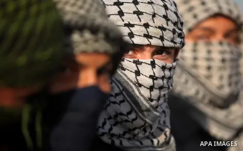 Masked Palestinian protersters look on during clashes with Israeli security forces at the Erez crossing checkpoint in the northern Gaza Strip October 16, 2015. The unrest that has engulfed Jerusalem and the occupied West...