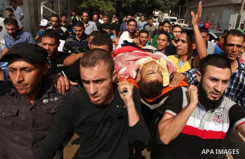 Relatives carry the body of Palestinian Mahmoud Hmead, 22, who was killed by Israeli troops in Friday's clashes, during his funeral in Gaza October 17, 2015. The unrest that has engulfed Jerusalem, Gaza and the occupied...