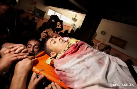 Relatives carry the body of Palestinian Mahmoud Hmead, 22, who was killed by Israeli troops in Friday's clashes, during his funeral in Gaza October 17, 2015. The unrest that has engulfed Jerusalem, Gaza and the occupied...