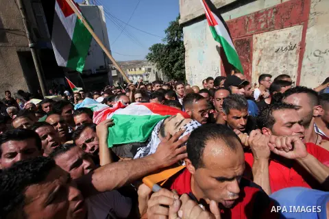 Mourners carry the body of Palestinian Ihab Hanani, 19, during his funeral at the Bet Forik village near the West Bank city of Nablus, on October 17, 2015. The unrest that has engulfed Jerusalem, Gaza and the occupied We...