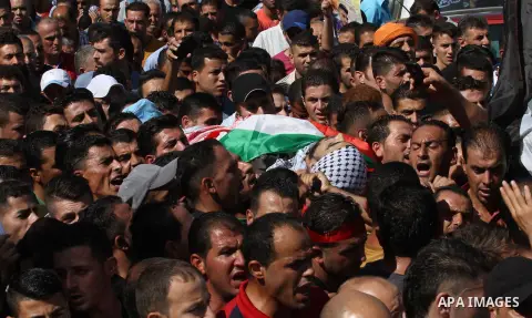 Mourners carry the body of Palestinian Ihab Hanani, 19, during his funeral at the Bet Forik village near the West Bank city of Nablus, on October 17, 2015. The unrest that has engulfed Jerusalem, Gaza and the occupied We...