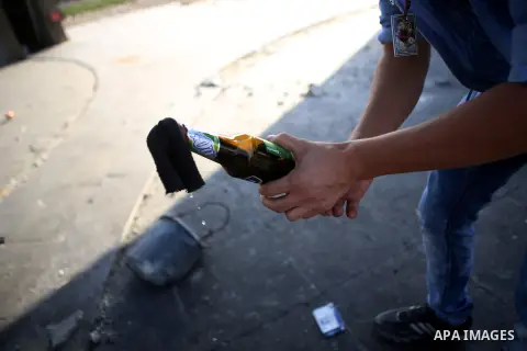 A Palestinian protester prepares molotov cocktails during clashes with Israeli security forces near the Beit El settlement on the outskirts of Ramallah in the West Bank, on October 17, 2015. The unrest that has engulfed...
