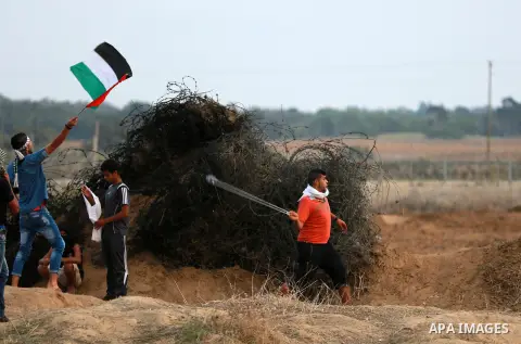 Palestinian protesters clash with Israeli troops near the border between Israel and Central Gaza Strip October 19, 2015. More than two weeks of unrest have raised warnings of the risk of a full-scale Palestinian uprising...