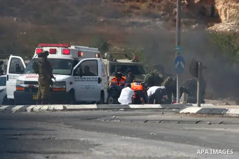 Israeli soldiers inspect the scene where a settler was ran over by a Palestinian truck driver in an incident that followed stone-throwing near Al Fawar Refugee camp near Hebron city, 20 October 2015. The Israeli settler...