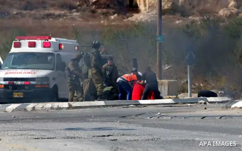 Israeli soldiers inspect the scene where a settler was ran over by a Palestinian truck driver in an incident that followed stone-throwing near Al Fawar Refugee camp near Hebron city, 20 October 2015. The Israeli settler...