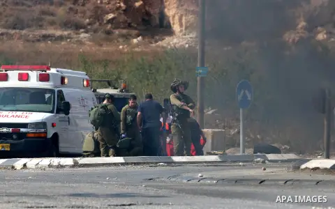 Israeli soldiers inspect the scene where a settler was ran over by a Palestinian truck driver in an incident that followed stone-throwing near Al Fawar Refugee camp near Hebron city, 20 October 2015. The Israeli settler...