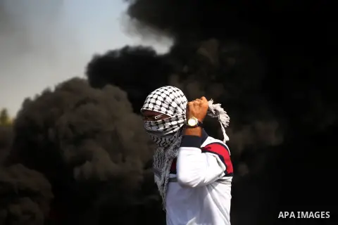 A Palestinian protester adjusts his mask during clashes with Israeli security forces near the Jewish settlement of Beit El, near the West Bank city of Ramallah October 20, 2015. Triggered by Israeli incursions into the A...